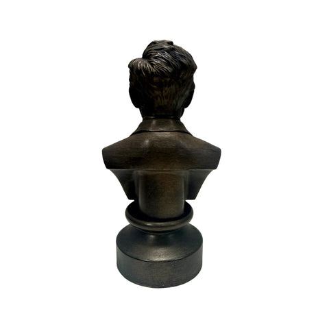 A back view of the bronze colored statue of the head of Abraham Lincoln up to the torso