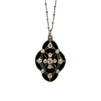 Silver pendant necklace in the same of a diamond with rounded edges with encrusted gemstones in the perimeter of the shape and a diamond group in the center of the pendant on a silver necklace
