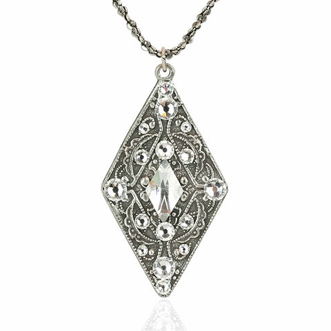 Silver crystal pendant in the shape of a diamond with encrusted white gemstones on a silver necklace