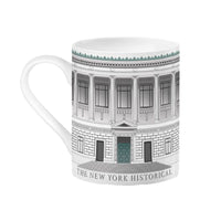 A white mug featuring a wrapped design of The New York Historical Facade 