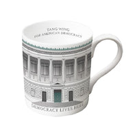 A white mug featuring a wrapped design of the The New York Historical Facade with the text 