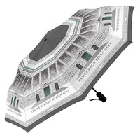A umbrella featuring a grey-toned wrapped design of the The New York Historical Facade  with the text 
