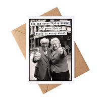 Greeting card with black and white photo of elderly couple giving thumbs up, text overlay, and brown envelope.