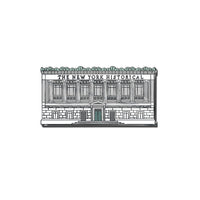 A lapel pin featuring a grey and light green design of the The New York Historical Facade 