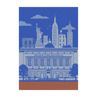 A kitchen towel featuring the design of The New York Historical Facade Building in blue and white with New York City's iconic skyline in the background and an orange border towards the bottom