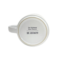 The bottom view of a white ceramic mug featuring the text 