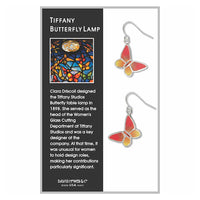 Tiffany Butterfly Lamp themed dangle earrings displayed on a branded card. The earrings feature a silver-tone metal frame with a stained-glass-inspired design in orange, yellow, and blue, with a silver dangling hook.