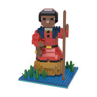 mini building blocks in the shape of Harriet Tubman on a body of water with green vegetation
