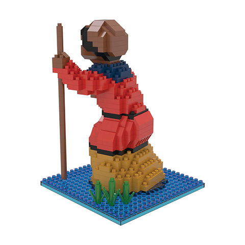 mini building blocks in the shape of Harriet Tubman on a body of water with green vegetation
