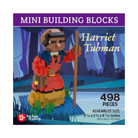 mini building blocks in the shape of Harriet Tubman on a body of water with green vegetation