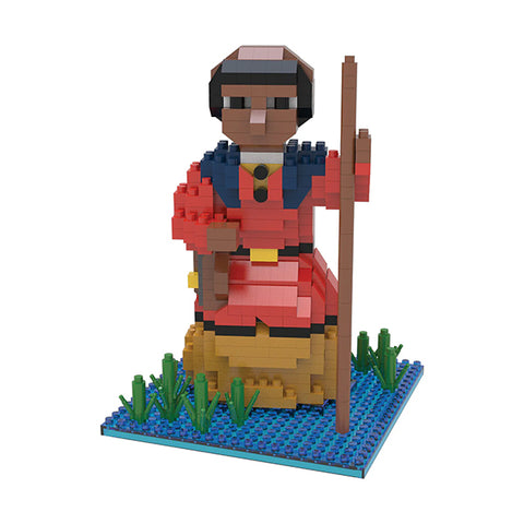 mini building blocks in the shape of Harriet Tubman on a body of water with green vegetation