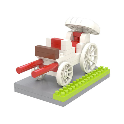 A miniature model of a white chariot with red handles on a gray base with a patch of green made from interlocking bricks 