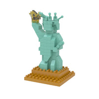 A miniature building block of a green statue of liberty with a yellow gold base and yellow gold torch