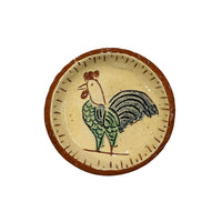 miniature terracotta plate with a drawing of a chicken in the middle with lines around the rim