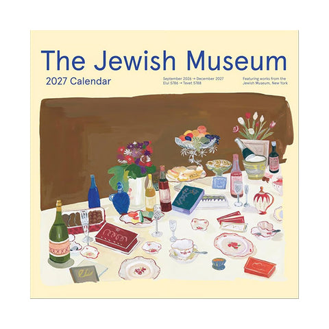 The cover of a 2027 Jewish Museum wall calendar that depicts a dinner table with a spread of food that includes chinaware, wine, drinks, desserts, and pastries with a vase of flowers at the center of the table