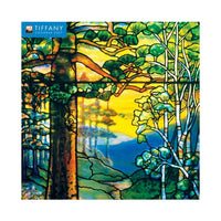 A 2027 Louis C. Tiffany Wall Calendar depicting a stained glass window design of a forest scene with trees and a sunset.