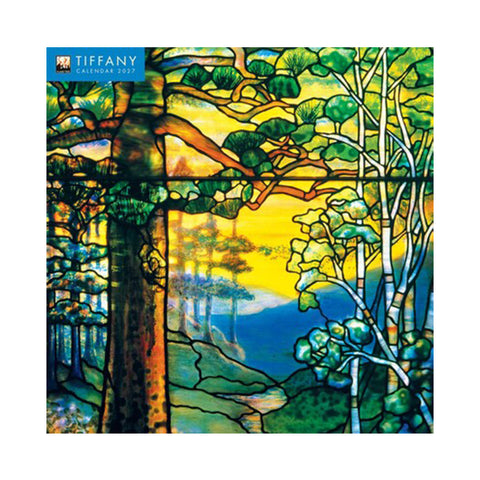 A 2027 Louis C. Tiffany Wall Calendar depicting a stained glass window design of a forest scene with trees and a sunset.