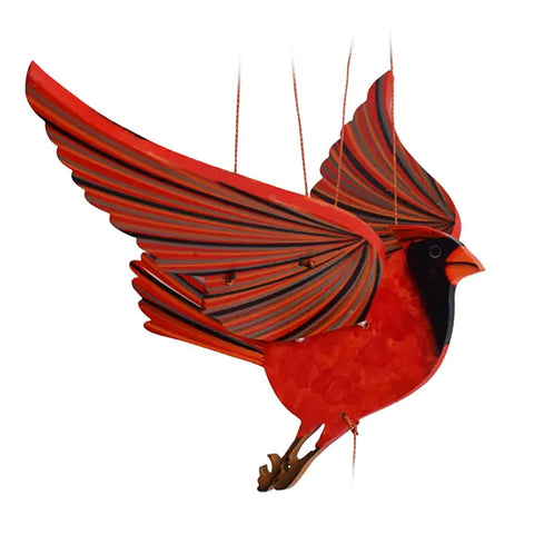 A hanging mobile cardinal bird with red and black striped wings, a bright red body, and a black head, suspended by thin strings