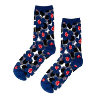 A pair of crew socks with a dense floral pattern featuring dark blue, black, and red flowers.