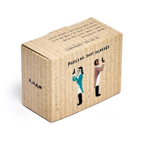 A square cardboard box with a textured kraft-paper finish, featuring black printed text and illustrations of two people holding shot glasses. The box is photographed at an angle.