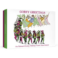 A boxed holiday card assortment titled "GOREY GREETINGS" with an illustration of figures in colorful historical clothing and bagpipes on a white box, shown against a light gray studio background.
