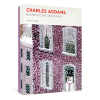 A boxed holiday card set titled "Charles Addams Brownstone Snowman" on a clean white background. The front cover shows an illustrated snow-covered brownstone building with snow falling and a snowman standing in a doorway.
