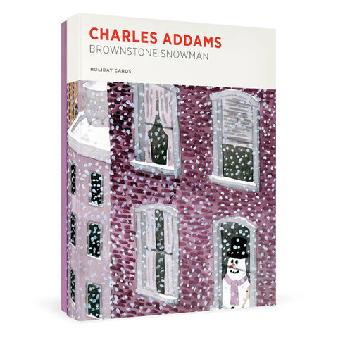 A boxed holiday card set titled "Charles Addams Brownstone Snowman" on a clean white background. The front cover shows an illustrated snow-covered brownstone building with snow falling and a snowman standing in a doorway.