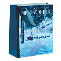 A New Yorker magazine cover gift bag featuring the December 16/17, 2021 cover illustration of Santa Claus in a sleigh flying over snow, with blue handles and a blue side panel.