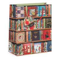 A gift bag featuring an illustration of three bookshelves filled with vintage books, with a red handle