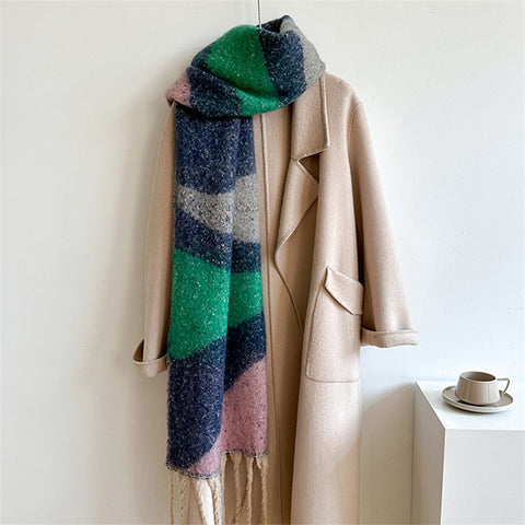 Beige coat with a green, pink, and blue patterned scarf on a white background
