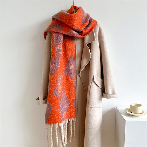 Beige coat with a red and orange patterned scarf on a white background