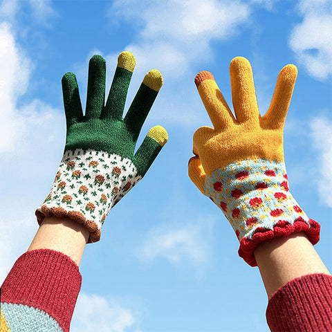 Feature a pair of hands in the air wearing a two-tone winter gloves with floral patterns against a blue sky.
