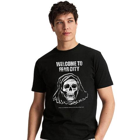 A man wearing a black short-sleeve t-shirt with a distressed graphic of a hooded skull and the text 'WELCOME TO FEAR CITY' on the front.