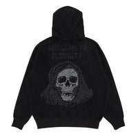 A black hooded sweatshirt featuring the text 'WELCOME TO FEAR CITY' above a hooded grim reaper skull illustration. The graphic is pixelated in rhinestones.