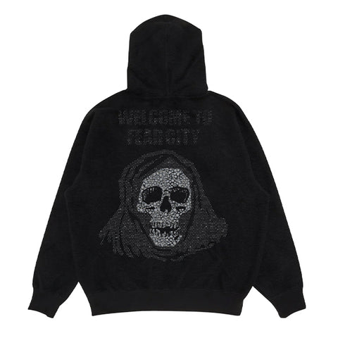 A black hooded sweatshirt featuring the text 'WELCOME TO FEAR CITY' above a hooded grim reaper skull illustration. The graphic is pixelated in rhinestones.