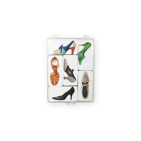 A case of six magnets featuring various shapes and colors of high heeled shoes