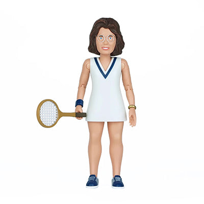 A brown hair woman wearing eyeglasses and a white tennis dress with a blue v accent collar holding a tennis racket with blue tennis sneakers and light blue laces